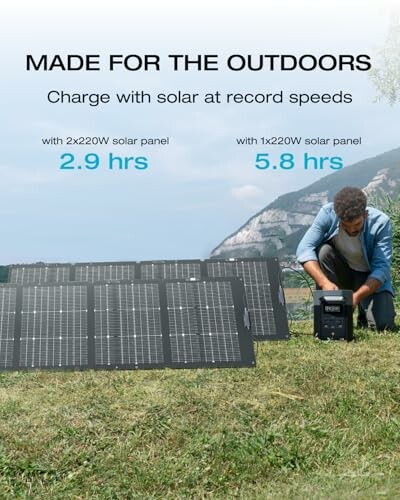 Man setting up solar panel outdoors with mountains in background.