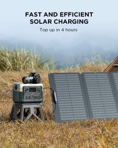 Portable solar charger with camera and power bank in a field.